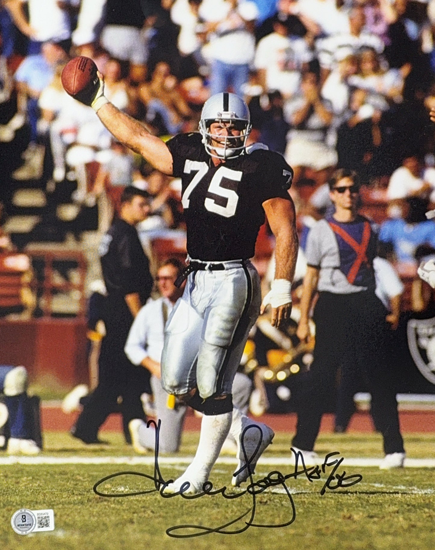 Howie Long Autographed Oakland Raiders Holding Out Football 11x14 Beckett